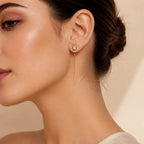 "Woman wearing gold vintage halo threader earring with chain drop"