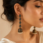 Woman wearing antique gold jhumka earring with blue crystal and pearl fringe, close-up ethnic jewelry photo