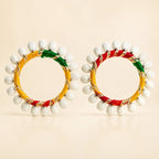 Set of two multicolor silk thread bangles with white shell drop bead fringe in yellow red green resham and gold zari