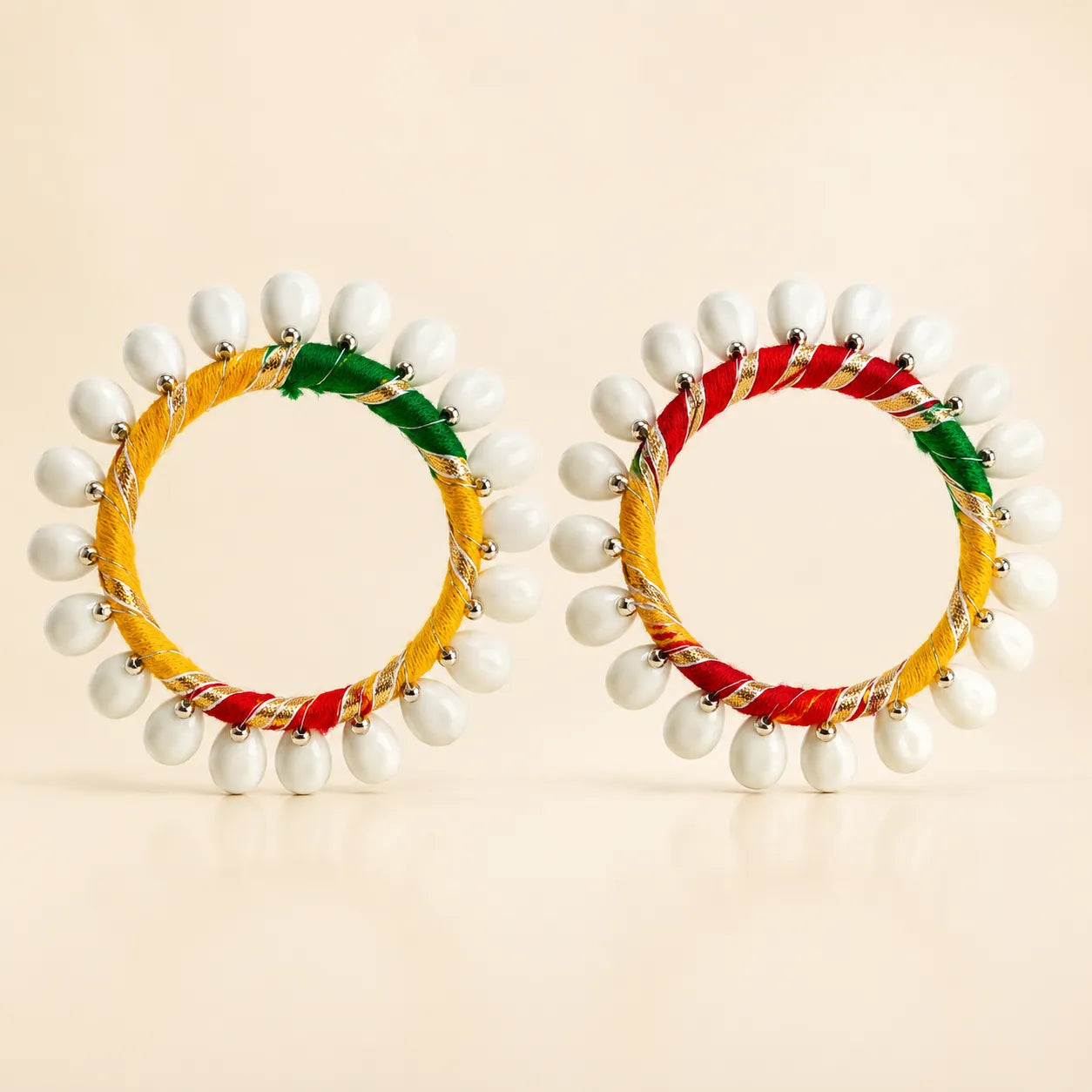 Set of two multicolor silk thread bangles with white shell drop bead fringe in yellow red green resham and gold zari