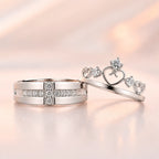 Silver his and hers couple ring set — wide CZ band and crown tiara heart ring displayed together on sparkle background