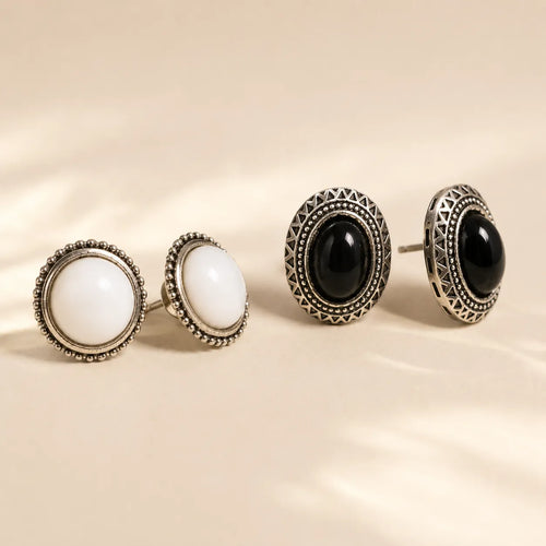 "Black and white stone stud earrings side by side showing silver beaded detail"