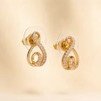 "Pair of gold CZ infinity swirl stud earrings with crystal detailing"