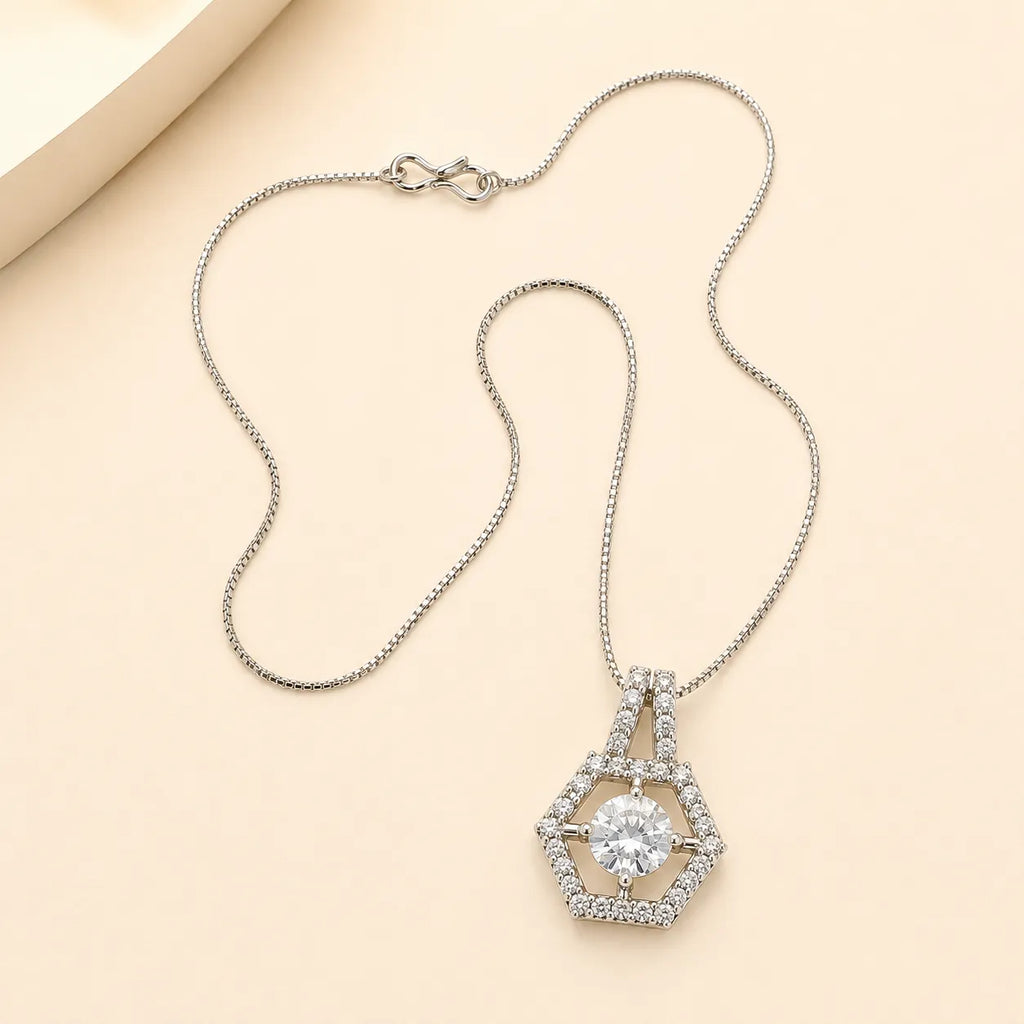 Silver hexagon halo necklace with round cut CZ center stone and double-bail chain detail on beige background