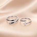 "Set of two matching silver wrap rings, one plain and one with CZ stone"