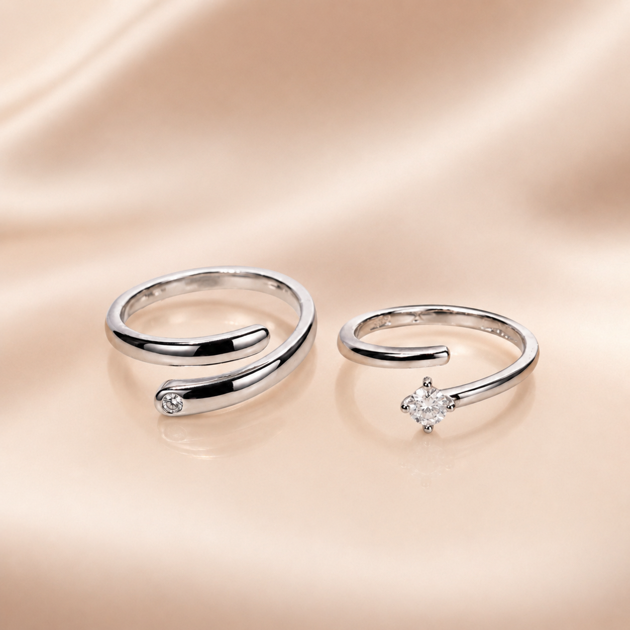 "Set of two matching silver wrap rings, one plain and one with CZ stone"