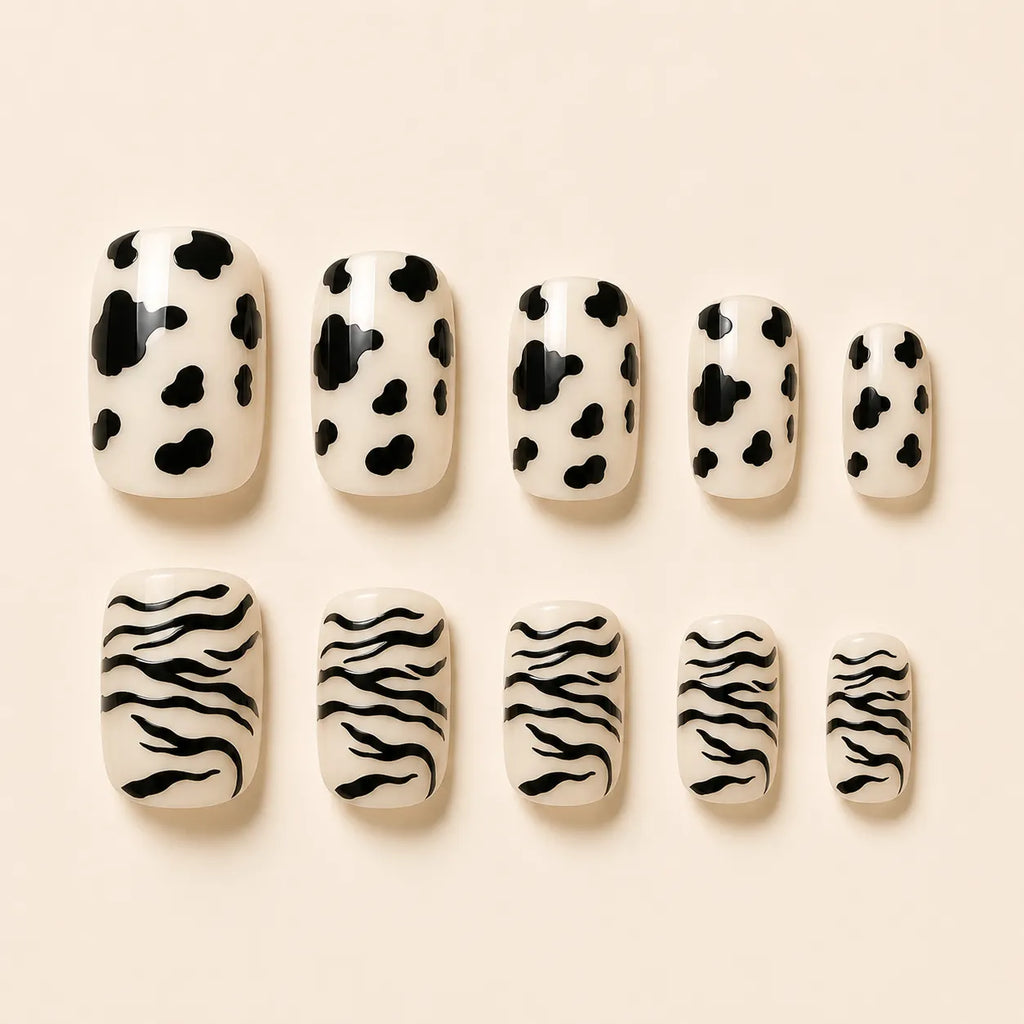 SAVNI cow print and zebra print press-on nails, 10-piece glossy animal print fake nail set on beige background
